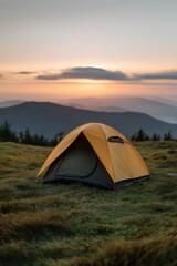 Orange tent on mountain at sunset with scenic horizon view