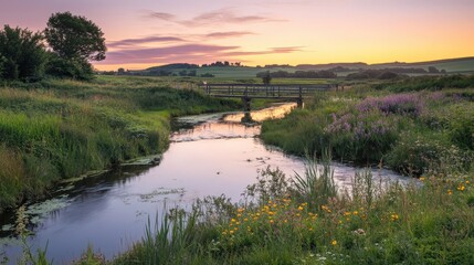 Peaceful sunset over a river with lush green banks and wildflowers, creating a calm and serene landscape.