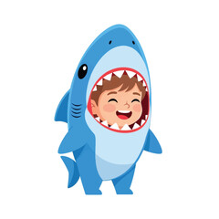 A happy child wearing a blue shark costume with the shark's mouth framing the child's face.