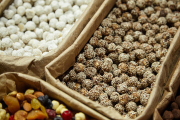 Assorted healthy snacks displayed in eco-friendly packaging, featuring a variety of nuts, dried fruits, and energy balls, showcasing vibrant colors and textures for nutritious choices