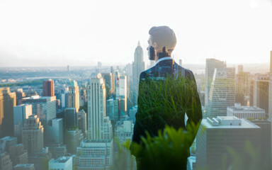 Businessman double exposure with cityscape, green sustainability concept and modern corporate vision