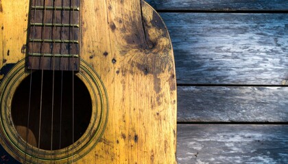 Obraz premium Close-up of a wooden string instrument neck—likely a guitar—resting on a weathered wooden surface