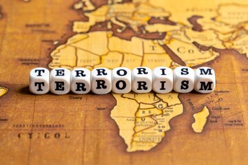 Wooden blocks with the text, TERRORISM, on the background of world map.