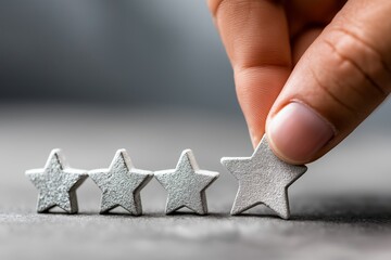 Hand removing a single star from a row of five silver stars, symbolizing dissatisfaction, service drop, or unmet expectations