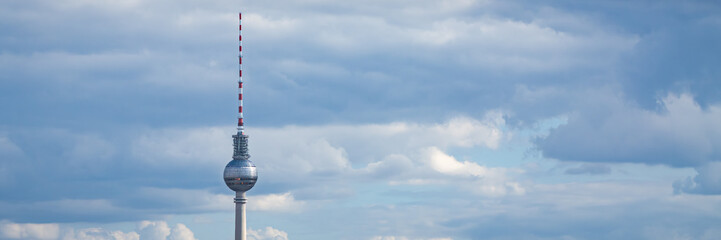 Close-up of Berlin TV Tower isolated against cloudy sky