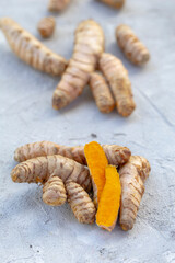 Fresh and Ground Turmeric Root on Rustic Background