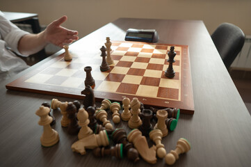 Close up of hands of middle aged caucasian man playing chess. 