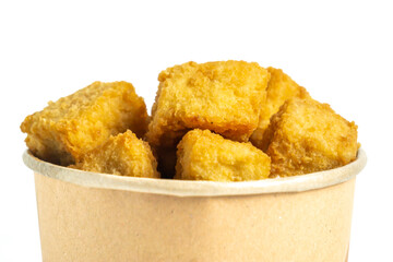 Crispy tofu (tahu crispy) in a paper bowl. Indonesian street food.
