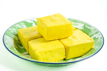 Tahu takwa (tahu kuning, tahu yellow tofu), traditional tofu from Kediri, East Java.This yellow color is tofu soaked with turmeric.