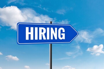 Fototapeta premium Hiring sign against a clear blue sky, encouraging viewers to take action. symbol, sign, illustration, job, sign up, job offer