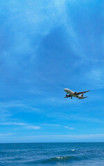 Passenger airplane flying over the sea on sunny day