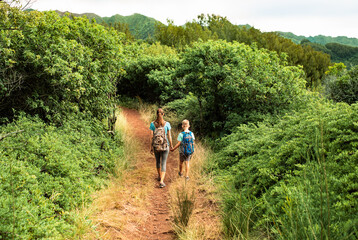 Obraz premium Mother son hiking in the mountains, family travel nature adventure concept 