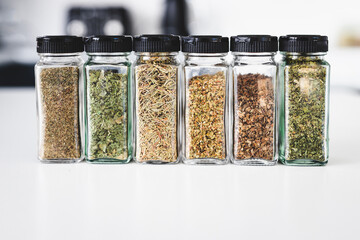 kitchen organization and tidy decanted pantry ingredients, glass jars filled with dried herbs