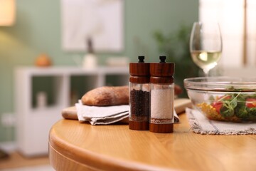 Tasty food and white wine on wooden table indoors, closeup