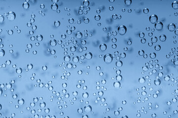 Soda water with bubbles of gas in glass, closeup