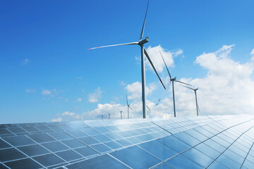 Solar panels and wind turbines against blue sky outdoors. Alternative energy source