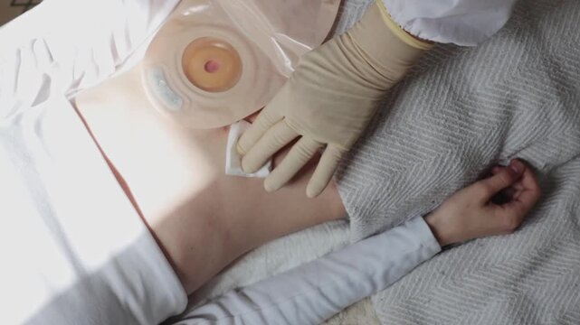 A nurse massages a patient's abdominal cavity after an injection.