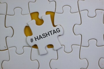 Fototapeta premium White Puzzle Piece with Hashtag Symbol on Yellow Background