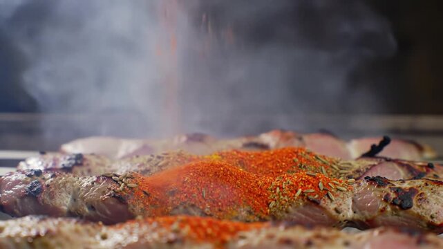 Seasoning Skewers: Aromatic Spices Falling on Grilled Meat with Smoke