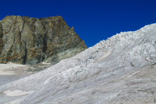Alps mountains snow ridges view of Monte Rosa massive. Lyskamm, Pollux and Castor summits above the clouds stunning landscape mountains view. Alps high attitude extreme terrain climbing and glacier