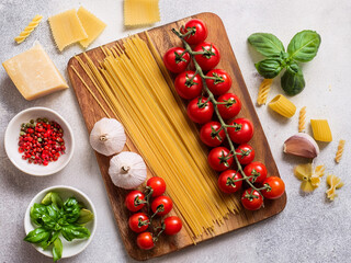 Overhead Flat Lay: Fresh Pasta Ingredients with Ripe Cherry Tomatoes and Basil Leaves

