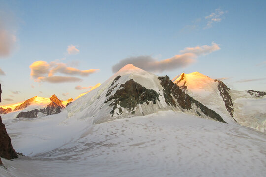 Alps mountains snow ridges view of Monte Rosa massive. Lyskamm, Pollux and Castor summits above the clouds stunning landscape mountains view. Alps high attitude extreme terrain climbing and glacier
