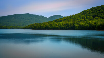 Chittenden Reservoir, a 750-acre lake in Vermont’s Green Mountains—tranquil New England summer landscape with forest reflections in still waters.