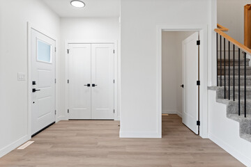 Hallway with a white door and a staircase