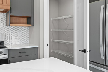 Kitchen with a white tile backsplash and a grey refrigerator