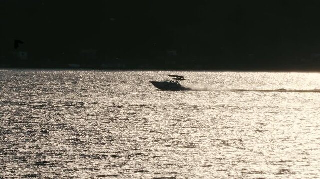 Boat driving in the distance lake sunny summer day slow motion silhouette distance