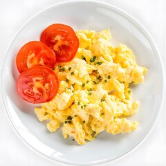 A plate of scrambled eggs with fresh tomato slices