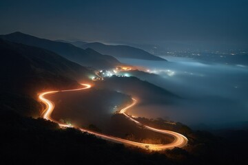 Winding mountain road at night, illuminated by light trails, shrouded in fog