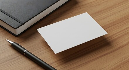 A blank business card floats above a wooden table, next to a pen and notebook.