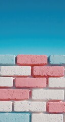 Obraz premium Pastel-colored brick wall against a vibrant blue sky
