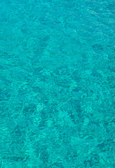 A view of crystal clear turquoise sea water that is soothing to the eyes. Background and pattern for design. Photo taken at Atauro Beach, Timor Leste.