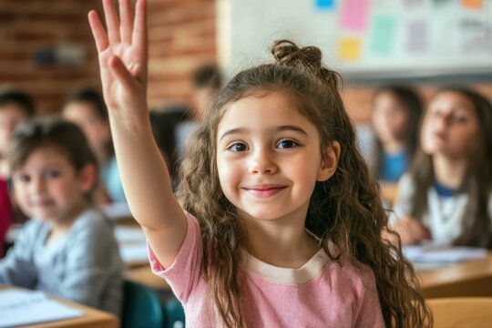 Cheerful student girl eager to answer, hand raised in elementary classroom with positive atmosphere