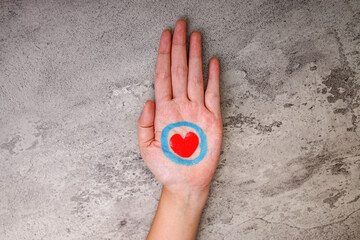 Close Up Of Woman Hand With Red Heart In Blue Ring Shows Compassion In Diabetes Support