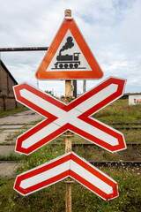 Ventspils, Latvia A railroad crossing sign in an old abandoned industrial landscape.