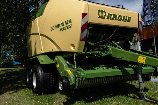 Omsk, Russian Federation - July 30, 2025: Krone Comprima CF 155 XC baler machine displayed outdoors, showcasing agricultural technology and innovation in a natural setting