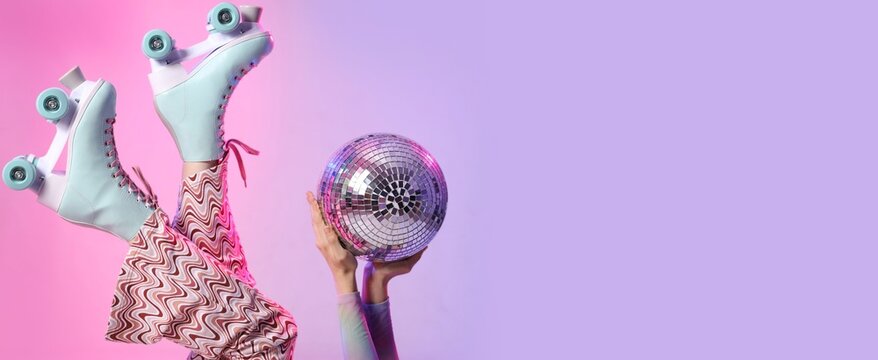 Young woman in roller skates holding disco ball on color background with space for text