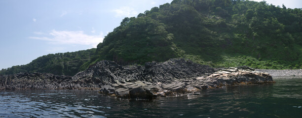Amazing Multi-layered lava rock on Iturup Island sea shore panoramic view
