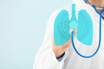 Naklejka premium Male doctor with stethoscope on light color background, closeup