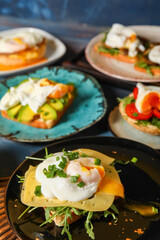 Plates with tasty eggs Benedict on table