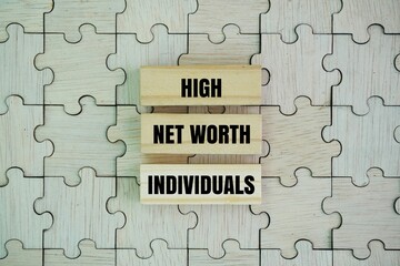 jigsaw puzzle and wooden arrangement with the words High Net Worth Individuals. all HNWIs will have to review their inheritance plans