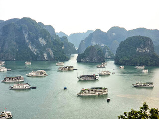Cruise ships among vertical cliffs in Halong Bay, Vietnam
