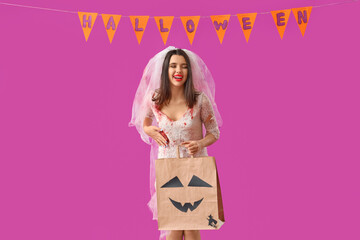 Young woman dressed for Halloween as dead bride with gift bag on purple background