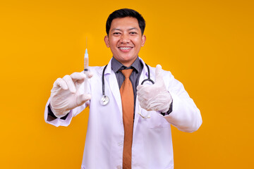 Cheerful Asian Male Doctor With Braces, Holding A Syringe And Giving Thumbs Up
