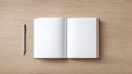 A wooden table with natural grain texture holds a closed hardcover book and a silver pen,