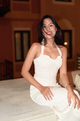 Young Asian woman tourist with long black hair in European style town at night