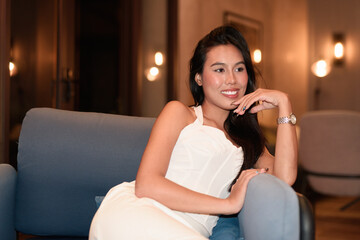 Young Asian woman tourist with long black hair in hotel sitting at night